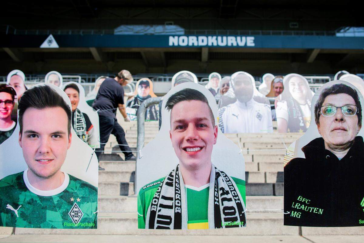 Dirk Kramer, member of supporters club brings the first “cardboard comrades” of soccer club Borussia Moenchengladbach, at the north curve in the stadium in Moenchengladbach, Germany, Thursday, April 9, 2020. The fans of Gladbach want to contribute to a better atmosphere at possible ghost games in the German Bundesliga. In order to spare the TV viewers and the professionals the view of the empty stadium seats, cardboard figures with the likeness of the supporters are to be set up in life-size - if desired, where the spectators also stand or sit during normal games. (Rolf Vennenbernd/dpa via AP)