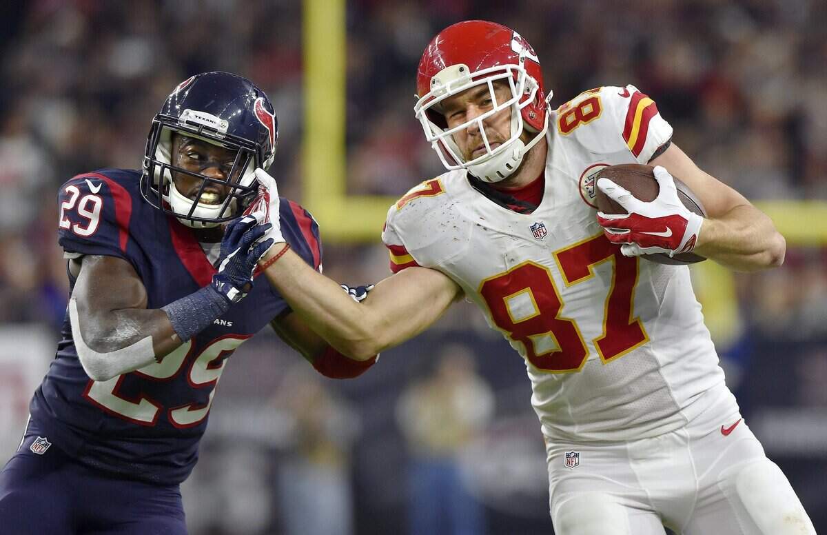 Travis Kelce fights off Houston Texans free safety Andre Hal after pulling in a pass during the AFC wild card game on January 9, 2016, at NRG Stadium in Houston.