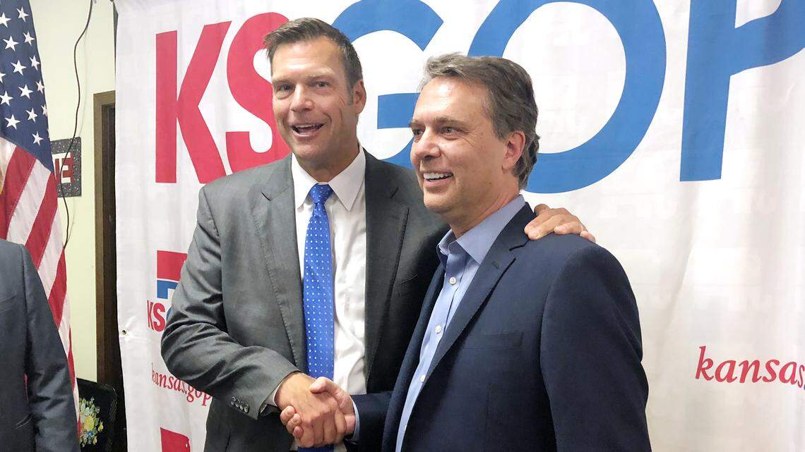 Kansas GOP gubernatorial nominee Kris Kobach (left) shook hands with Gov. Jeff Colyer during an event to show unity between the candidates after a close primary race in August.