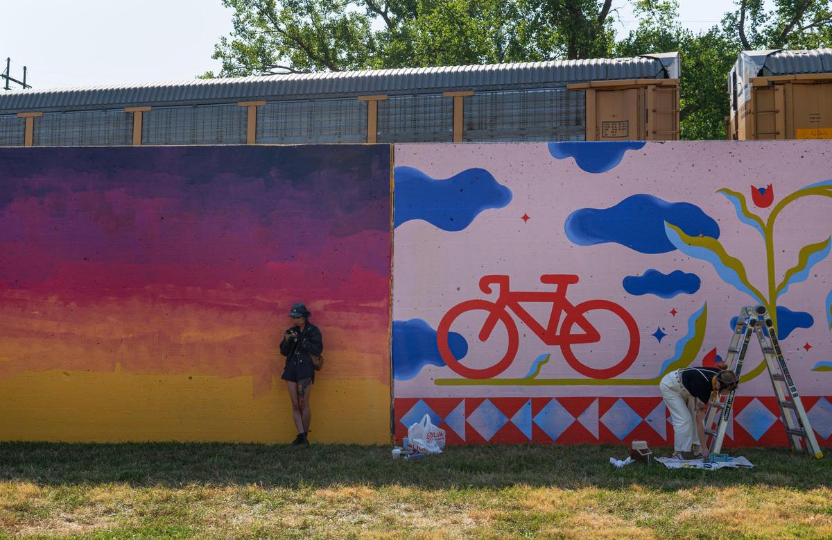 Emily Ding, left, designs her mural while Felicia Koloc puts the finishing touches on her piece “Joy Ride” on Friday, Sept. 15, 2023, at the Riverfront Heritage Trail in Kansas City. “Not only will it be educational and inspirational, I think that even when it’s a gloomy winter day, there’s going to be something beautiful and colorful to brighten your day,” Meredith Hoenes, Director of Communications for Port KC, said.