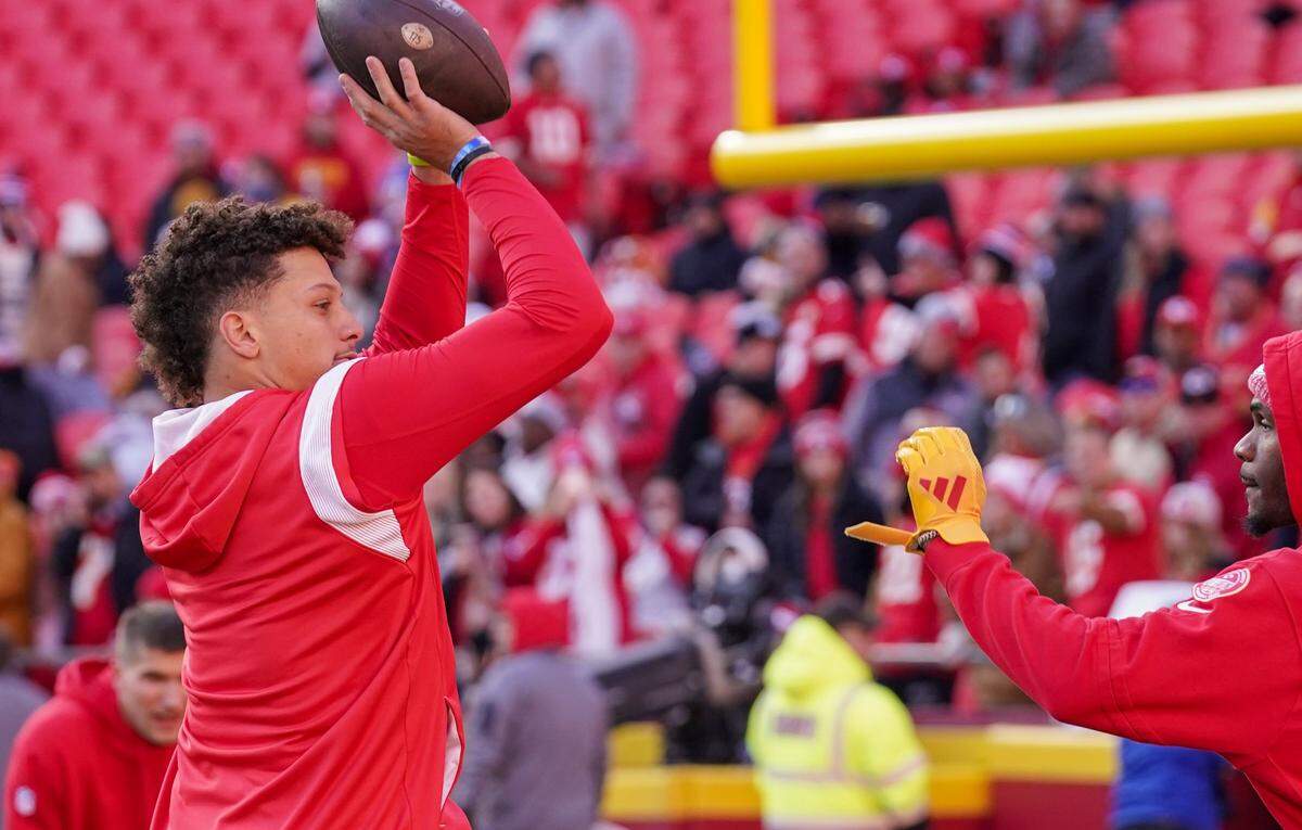 Kansas City Chiefs quarterback Patrick Mahomes mimics shooting basketball before a game at GEHA Field at Arrowhead Stadium.