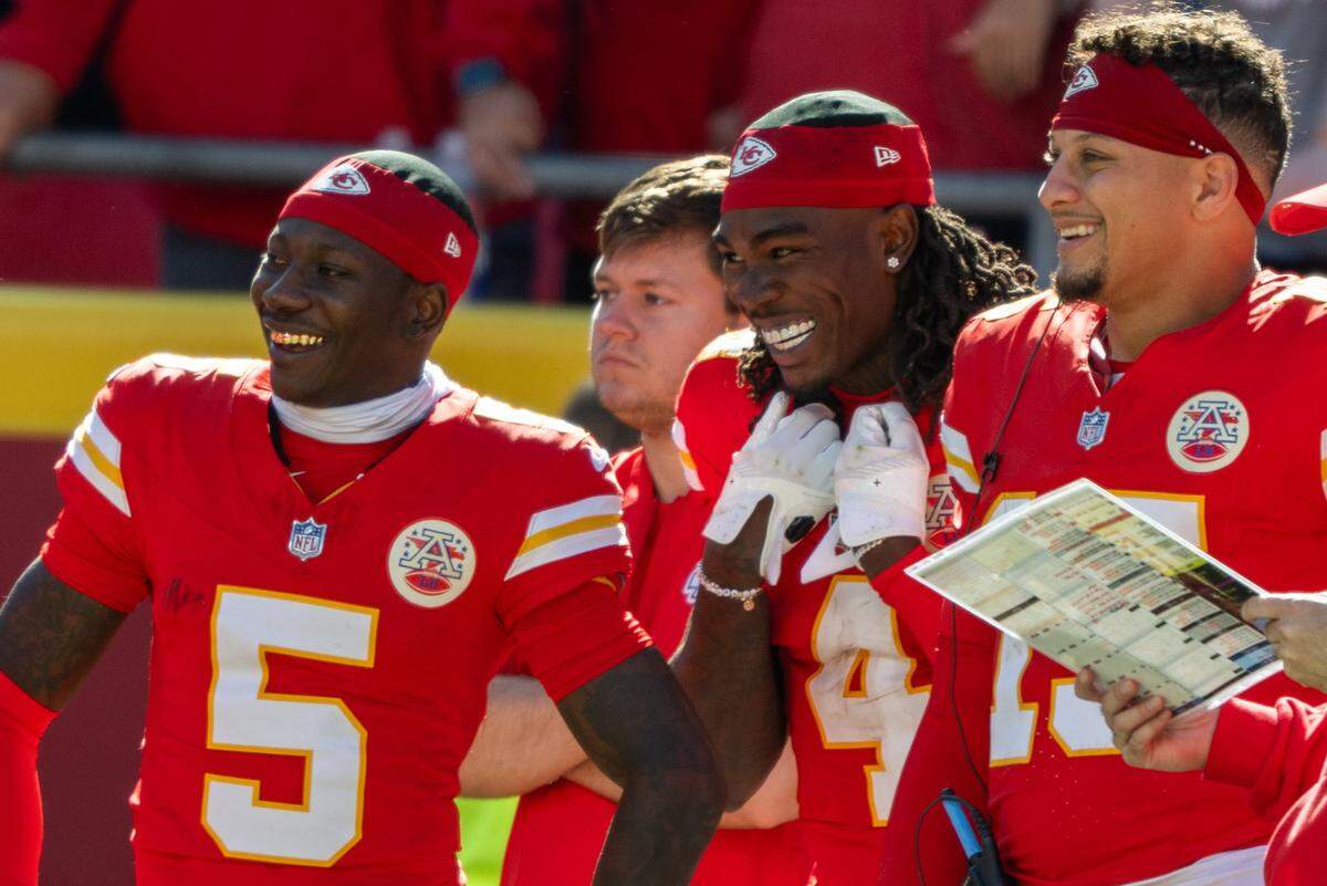 Chiefs receivers Marquise “Hollywood” Brown, from left, and Rashee Rice (No. 4) share a laugh with quarterback Patrick Mahomes (No. 15) on the sideline late in an NFL Week 7 win over the Las Vegas Raiders on Sunday, Oct. 19, 2025 at GEHA Field at Arrowhead Stadium in Kansas City.