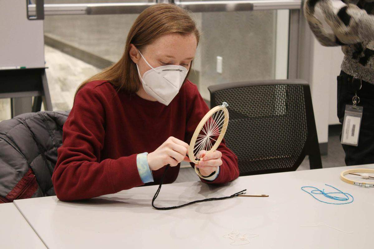 Emily Foley of Olathe works in her woven circle during a fiber arts class at the Downtown Olathe Library.