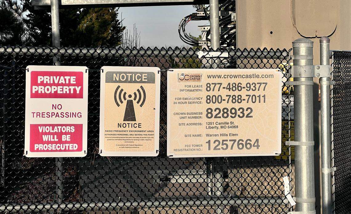 Signs on the fencing surrounding a cellular antenna, which stands very close to Warren Hills Elementary School in Liberty.