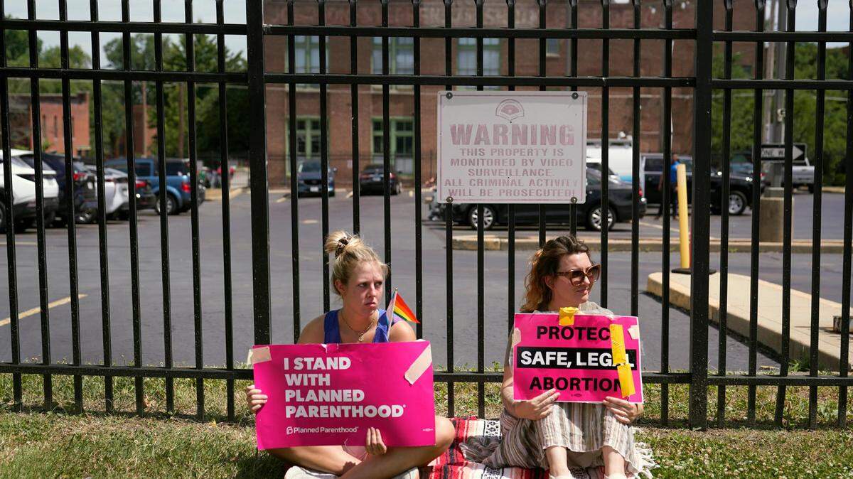 Protesters Kendal Underwood, left, and Brittany Nickens gather outside Planned Parenthood Friday, June 24, 2022, in St. Louis. Most abortions are now illegal in Missouri following a U.S. Supreme Court decision that ended a constitutional protection for abortion.
