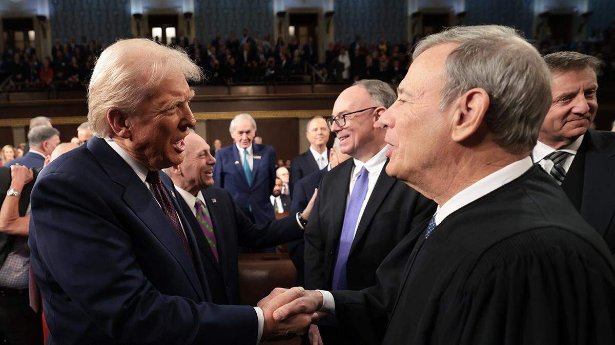 Mar 4, 2025; Washington, DC, USA; U.S. President Donald Trump (L) greets Chief Justice of the United States John G. Roberts, Jr as he arrives to deliver an address to a joint session of Congress at the U.S. Capitol on March 04, 2025 in Washington, DC. President Trump was expected to address Congress on his early achievements of his presidency and his upcoming legislative agenda. Mandatory Credit: Win McNamee-Pool via Imagn Images