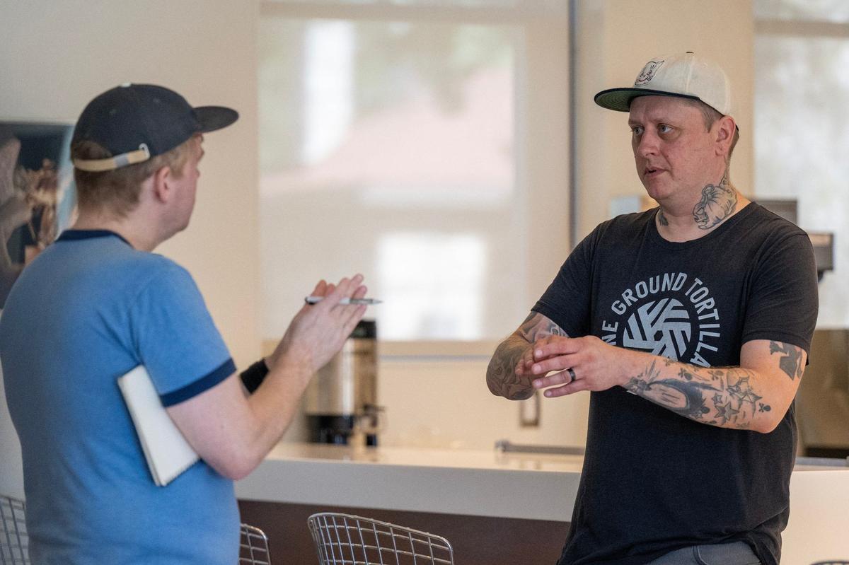 Chef Rick Mullins, right, goes over the presentation of dishes with friend Tyler Fox at the Kansas City Museum.