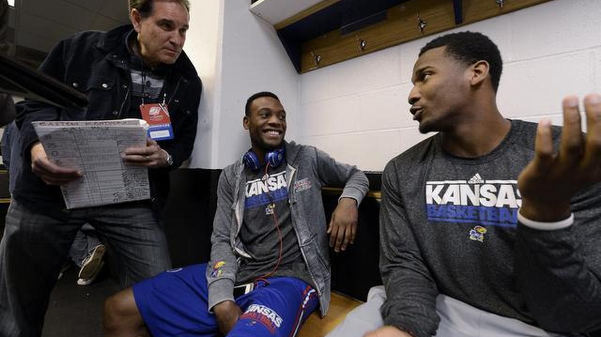 KU guards Naadir Tharpe (middle) and Wayne Selden (right) visit with CBS television sports commetator Jim Nance Saturday afternoon in the Jayhawks locker room at the Scottrade Center in St. Louis.