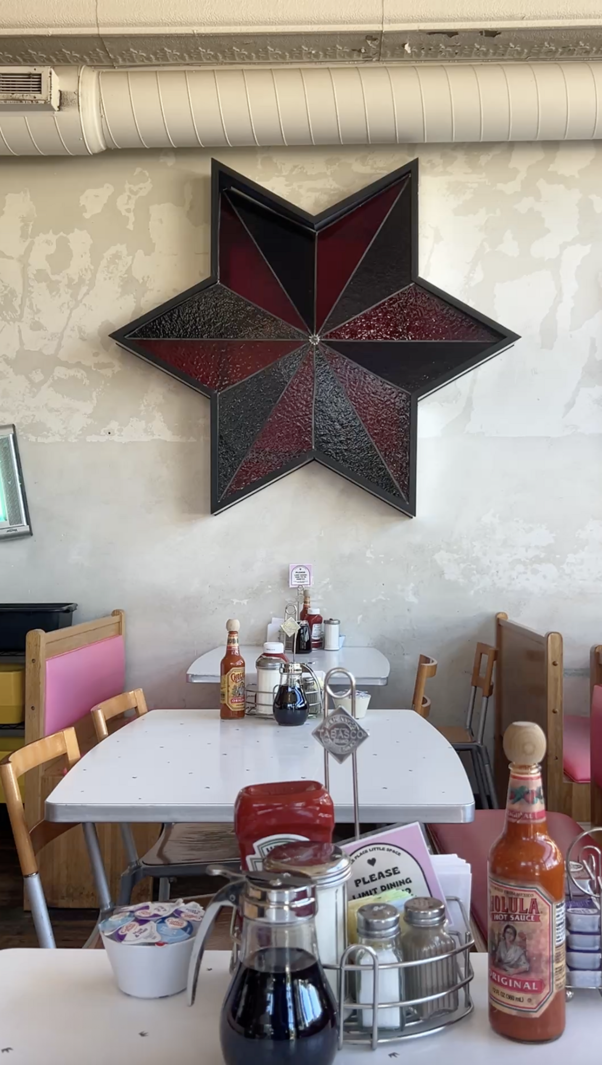 The maximalist Succotash has metal artwork, pink bench seats and chandeliers, street signs and paintings littered across the space.