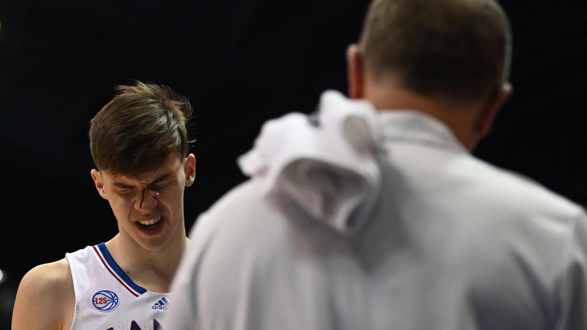 KU’s Zack Clemence heads for the team doctor after being injured during the second half of Thursday night’s game at Allen Fieldhouse. KU beat North Dakota State, 82-59.