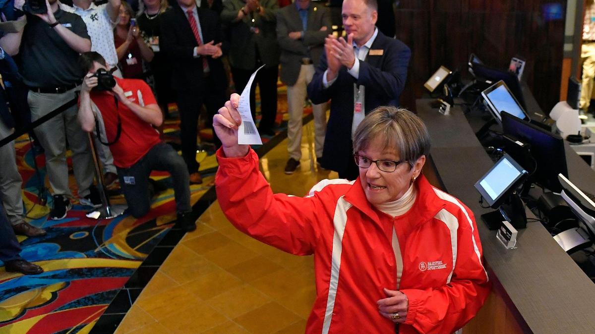 Legalized sports betting got underway Thursday in Kansas, including a location at the Hollywood Casino at Kansas Speedway, in Kansas City, Kansas. Kansas Gov. Laura Kelly placed the first bet and turned toward an enthusiastic crowd after putting her money on the Kansas City Chiefs. The temporary Barstool Sportsbook consists of 30 sports betting kiosks and five betting windows with odds boards and 45 high-definition televisions. The casino plans on opening a permanent Barstool Sportsbook in the fall.