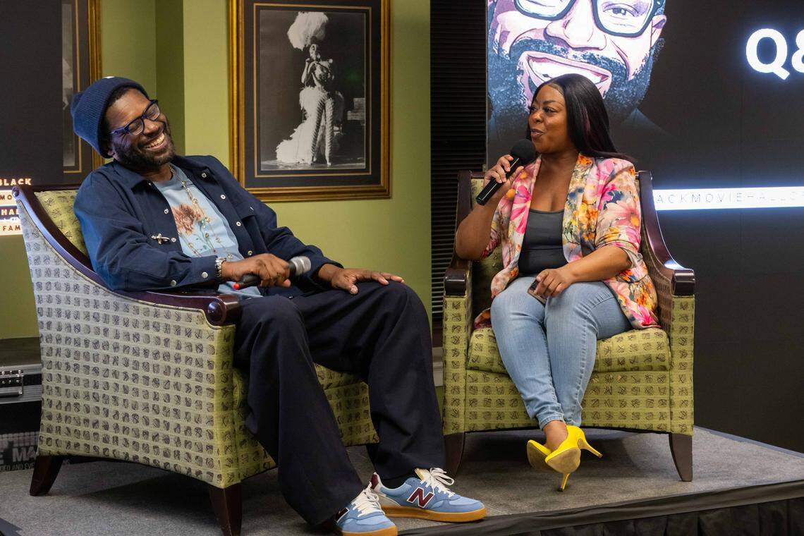 Film critic Shawn Edwards laughs with producer for FOX4, Kharissa Parker, at the launch event for the Black Movie Hall of Fame, at the Black Archives of Mid-America, on Saturday, February 28, 2026. Edwards has been a film critic for FOX4 for the last 25 years.