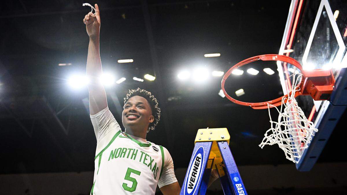 North Texas Mean Green guard Tylor Perry (5) cuts the net after defeating the UAB Blazers to win the NIT Championship at Orleans Arena in Las Vegas on March 30, 2023.
