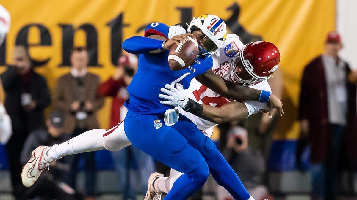 Kansas Jayhawks quarterback Jalon Daniels is tackled by Arkansas Razorbacks defensive lineman Jordan Domineck during Wednesday evening’s Liberty Bowl game in Memphis, Tenn.