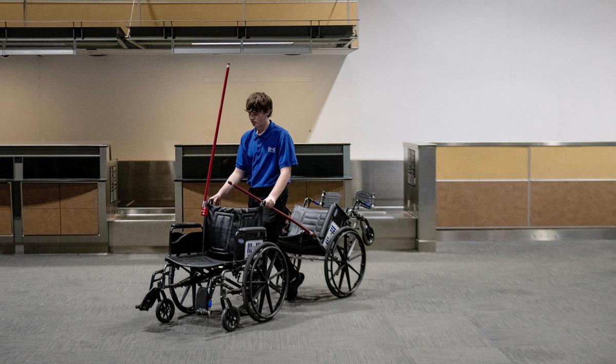 Carson Weir moves wheelchairs outside of terminal B on the last day of operation at Kansas City International Airport’s old terminals on Monday, Feb. 27, 2023, in Kansas City.