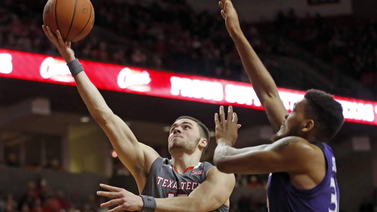 Texas Tech’s Matt Mooney (13) lays up the ball around Kansas State’s Levi Stockard III (34) during the first half of an NCAA college basketball game Saturday, Jan. 5, 2019, in Lubbock, Texas. (AP Photo/Brad Tollefson)