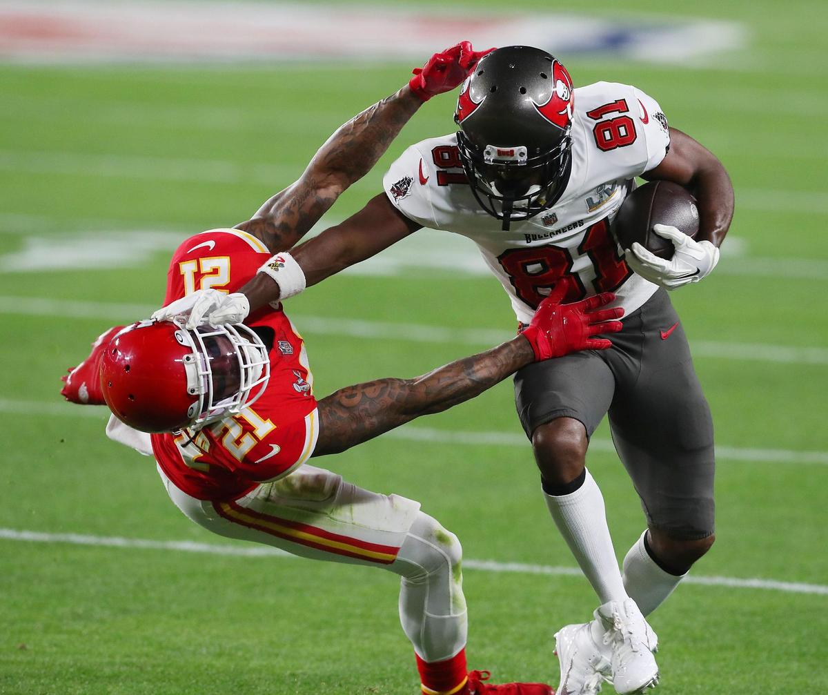 Tampa Bay Buccaneers wide receiver Antonio Brown stiff arms Kansas City Chiefs cornerback Bashaud Breeland in the first quarter Sunday, February 7, 2021, at Super Bowl LV at Raymond James Stadium in Tampa, Florida.
