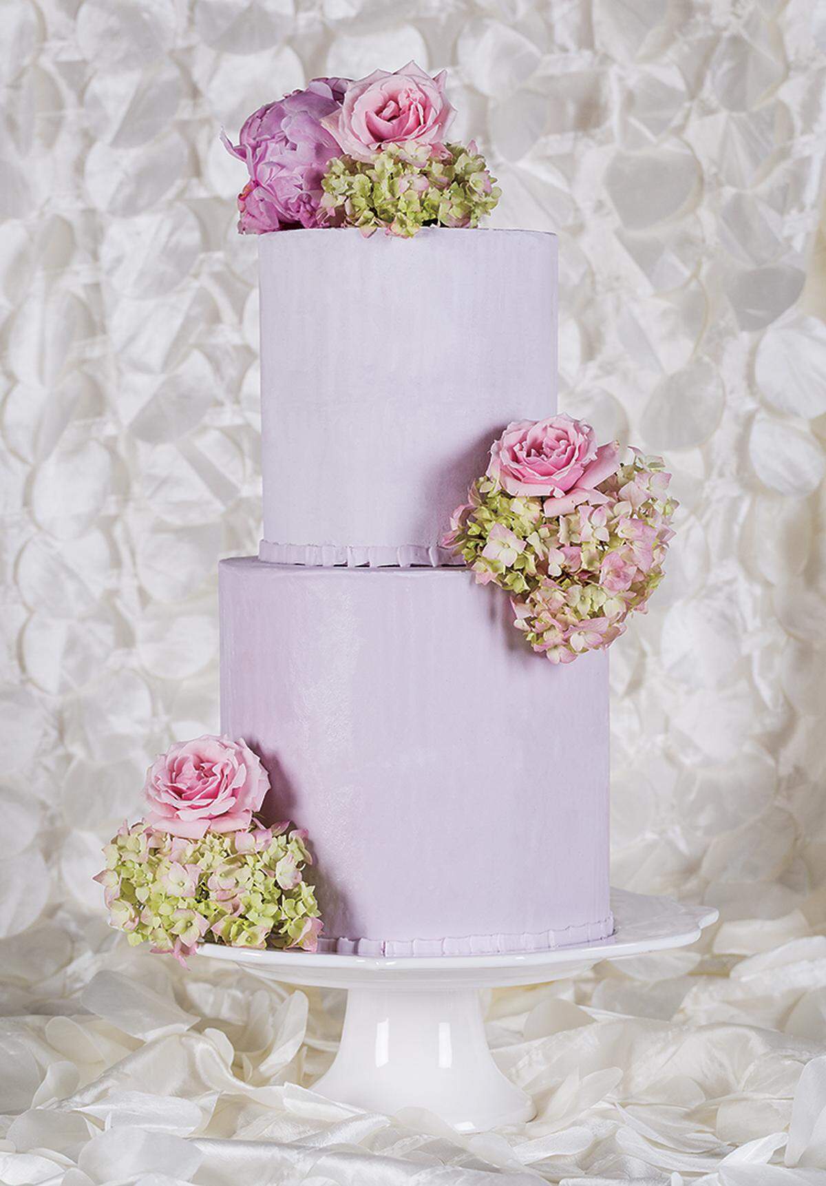 ALL IN BLOOM Hydrangeas, roses and peonies top off a classic two-tier pastel cake from Morello Fine Cakes. Cake stand available to rent from Ultrapom.