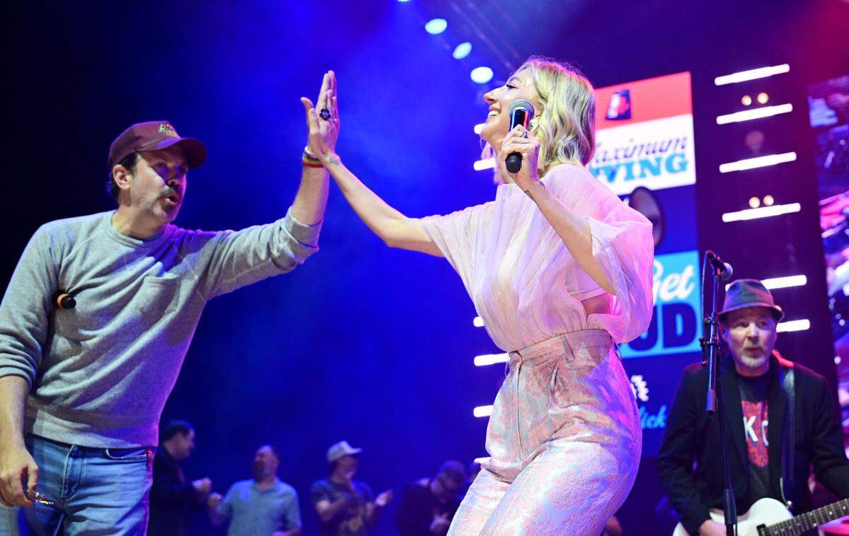 Co-hosts Jason Sudeikis and Heidi Gardner high five on stage Saturday, May 31, 2025, during the Big Slick Party and Show at T-Mobile Center in Kansas City.