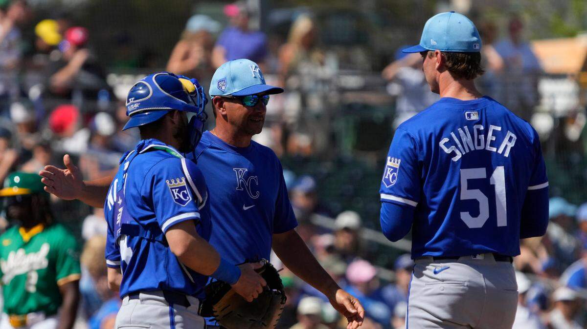 Kansas City Royals pitching coach Brian Sweeney (85) talks to his players against the Oakland Athletics in the second inning at Hohokam Stadium on March 10, 2024.