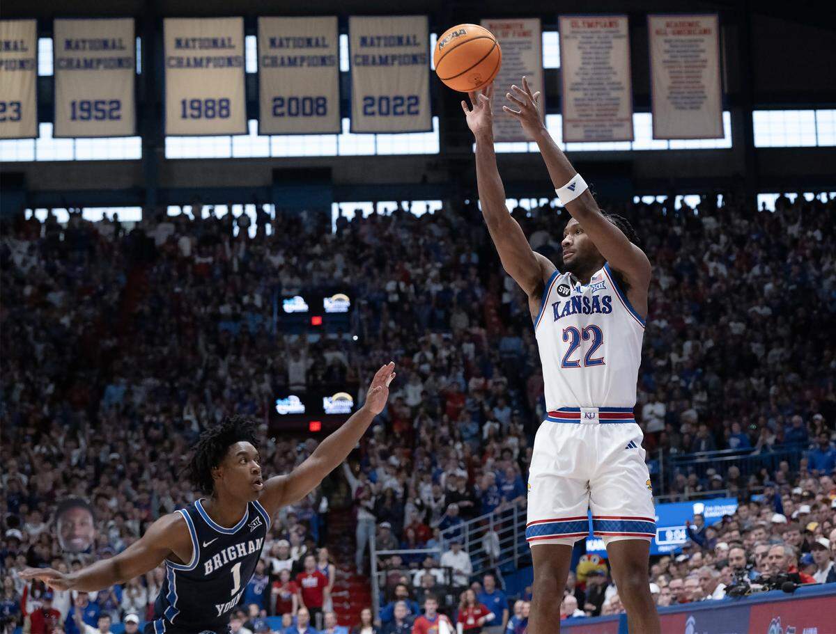 Kansas Jayhawks guard Darryn Peterson (22) gets a three-point shot off as BYU Cougars guard Robert Wright III (1) defends in the first half at Allen Fieldhouse on Saturday, Jan. 31, 2026, in Lawrence.