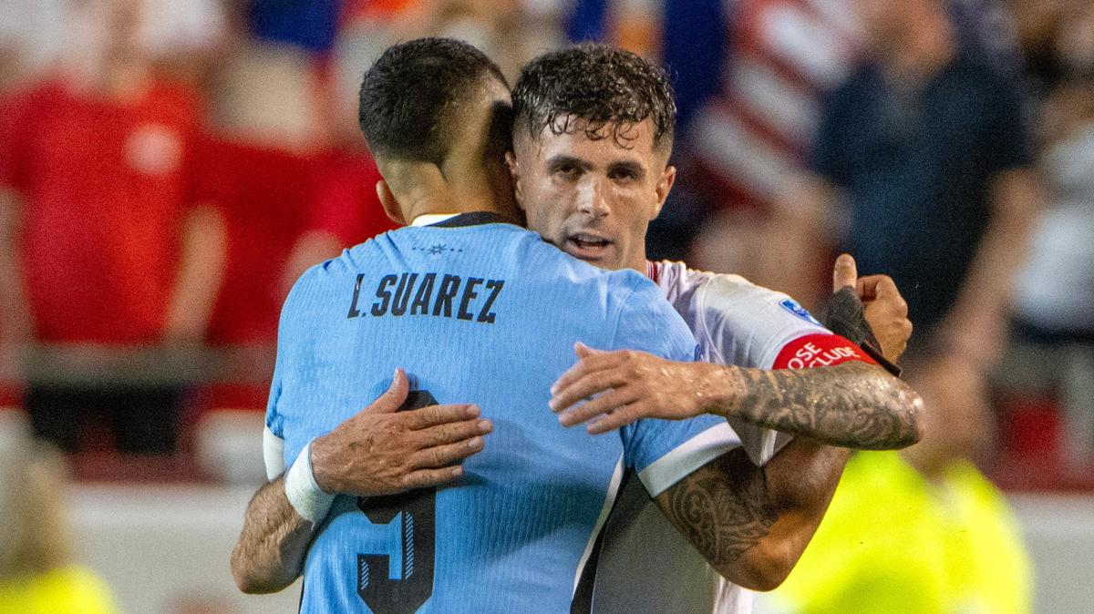 Uruguay forward Luis Suárez (9) embraces United States forward Christian Pulisic (10) after defeating the United States 1-0 in a Copa America match at GEHA Field at Arrowhead Stadium on Monday, July 1, 2024, in Kansas City.