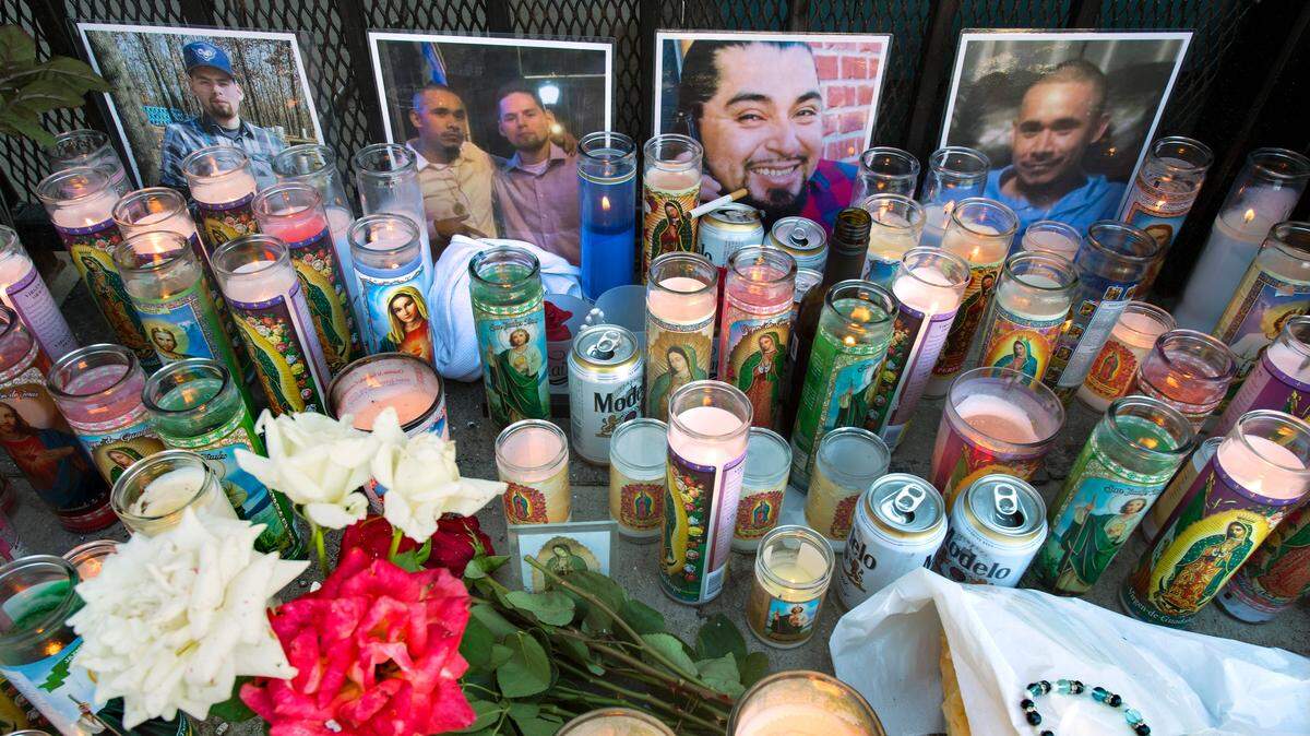 A memorial for three of the four men killed in a mass shooting at Tequila KC bar in Kansas City, Kansas, sits behind the bar. The victims seen in the photographs include Everardo Meza (left), Alfredo Calderon, Jr., and Everado Meza together, Francisco Garcia Anaya and an additional photo of Calderon (right).
