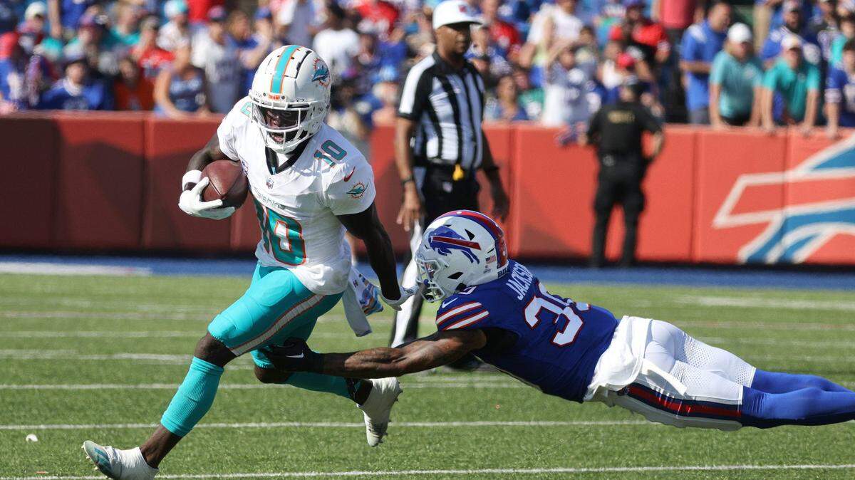 Dolphins receiver Tyreek Hill tries to slip a tackle by Bills Dane Jackson.