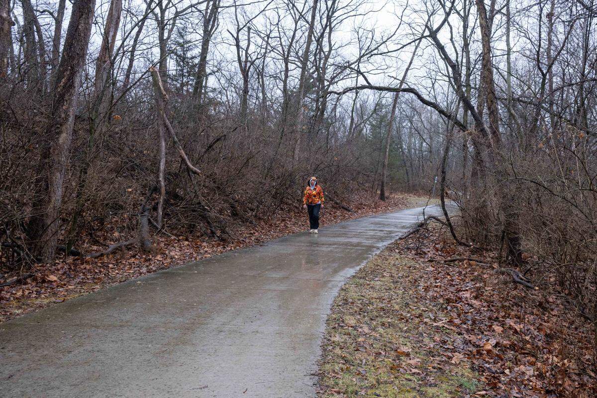A woman walks along Line Creek Trail near NW Barry Road, on Tuesday, March 3, 2026, in Kansas City. A group of residents is advocating against the city's proposed street plan, which includes plans to put a parkway through the Line Creek Forest to support a development project.