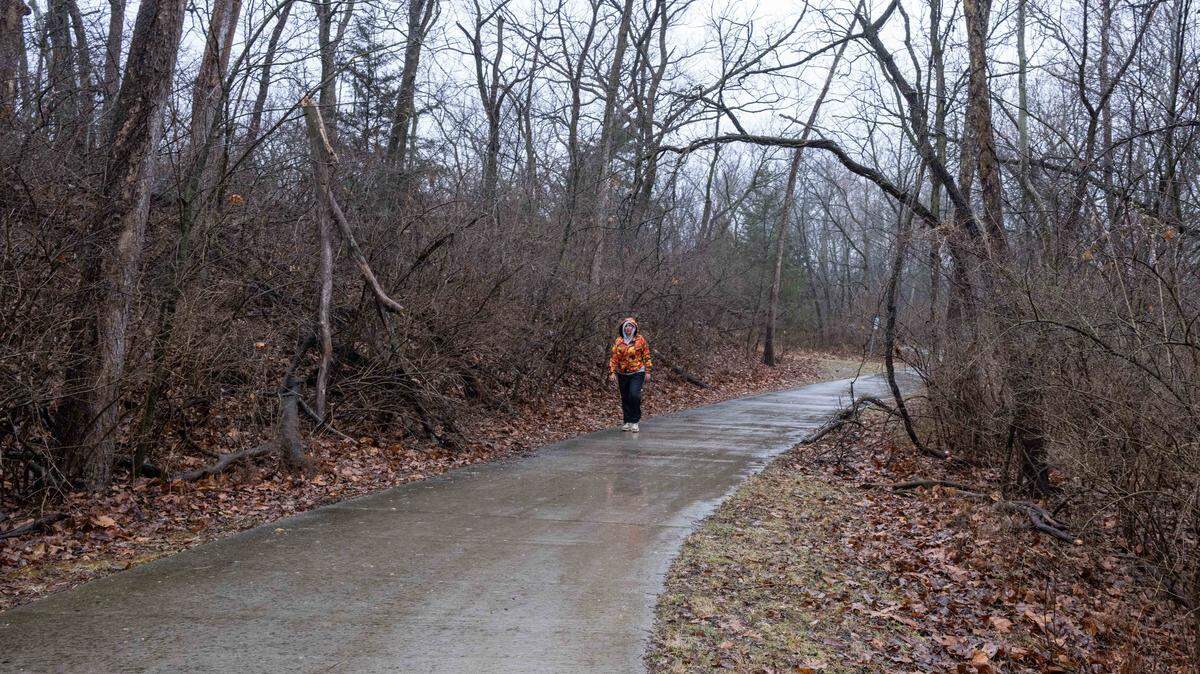 A woman walks along Line Creek Trail near NW Barry Road, on Tuesday, March 3, 2026, in Kansas City.