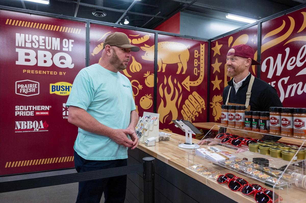 David Gist, a visitor from Mississippi, chats with Alex Pope at the Museum of BBQ on Wednesday in Kansas City. Pope is a partner in the business with founder Jonathan Bender.
