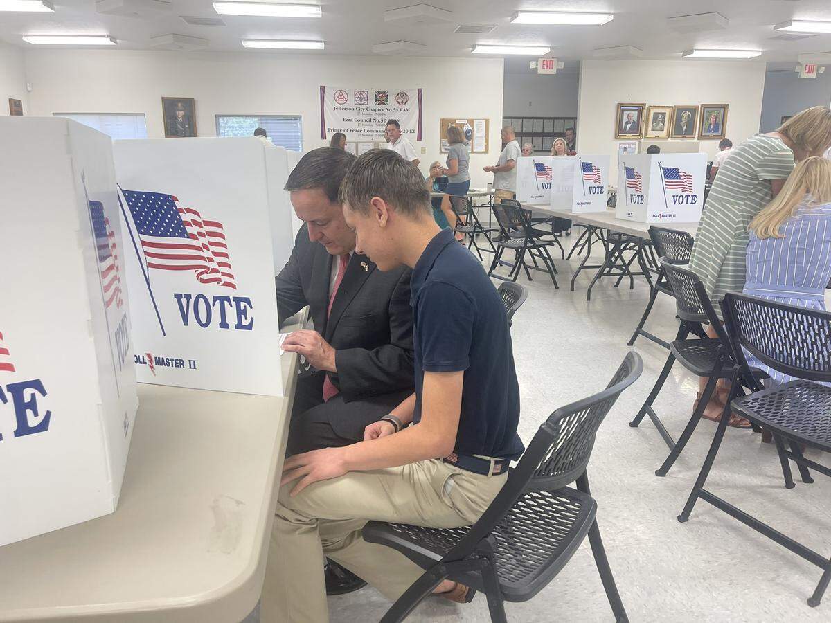 Secretary of State Jay Ashcroft, left, casts his ballot with his 15-year-old son, Samuel, on Aug. 6, 2024 in Jefferson City.