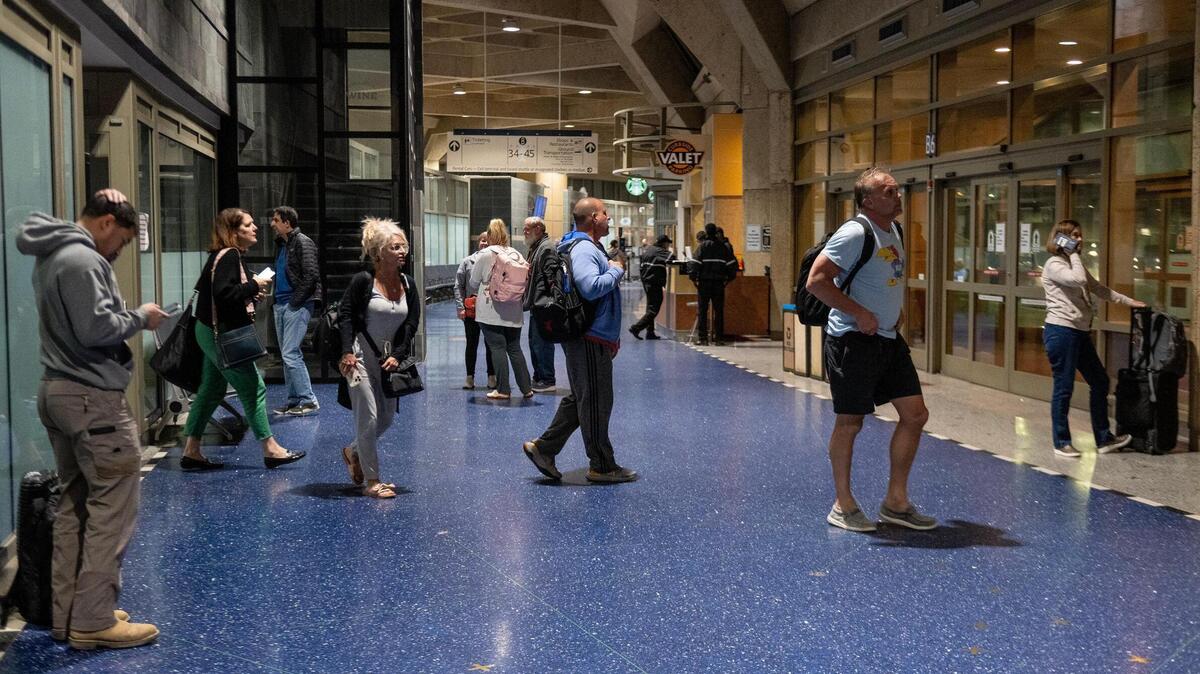 People exit the gate area in terminal B after exiting a flight on the last day of operation at Kansas City International Airport’s old terminals on Monday, Feb. 27, 2023, in Kansas City.