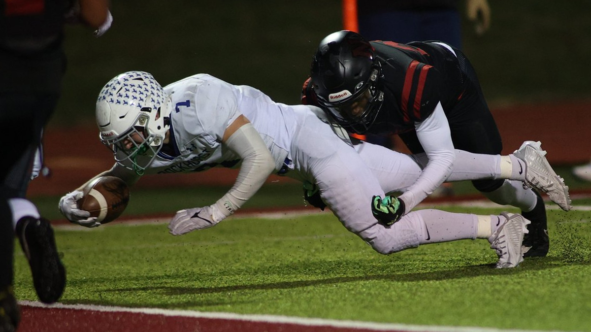 Rockhurst High’s Aidan Ryan dives for the goal line during the Hawklets’ 24-21 victory over Lee’s Summit North on Friday night.