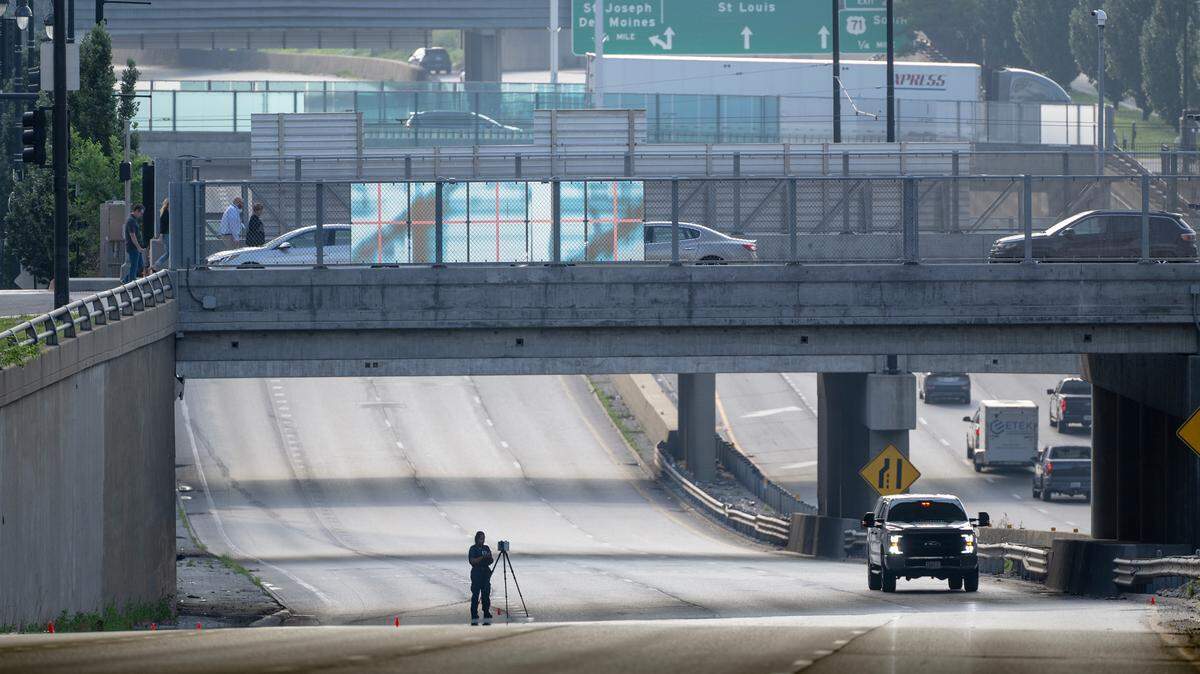 A Kansas City police officer works the scene of a fatal shooting on westbound lanes of Interstate 670 near Broadway Boulevard on Wednesday, June 7, 2023, in Kansas City.