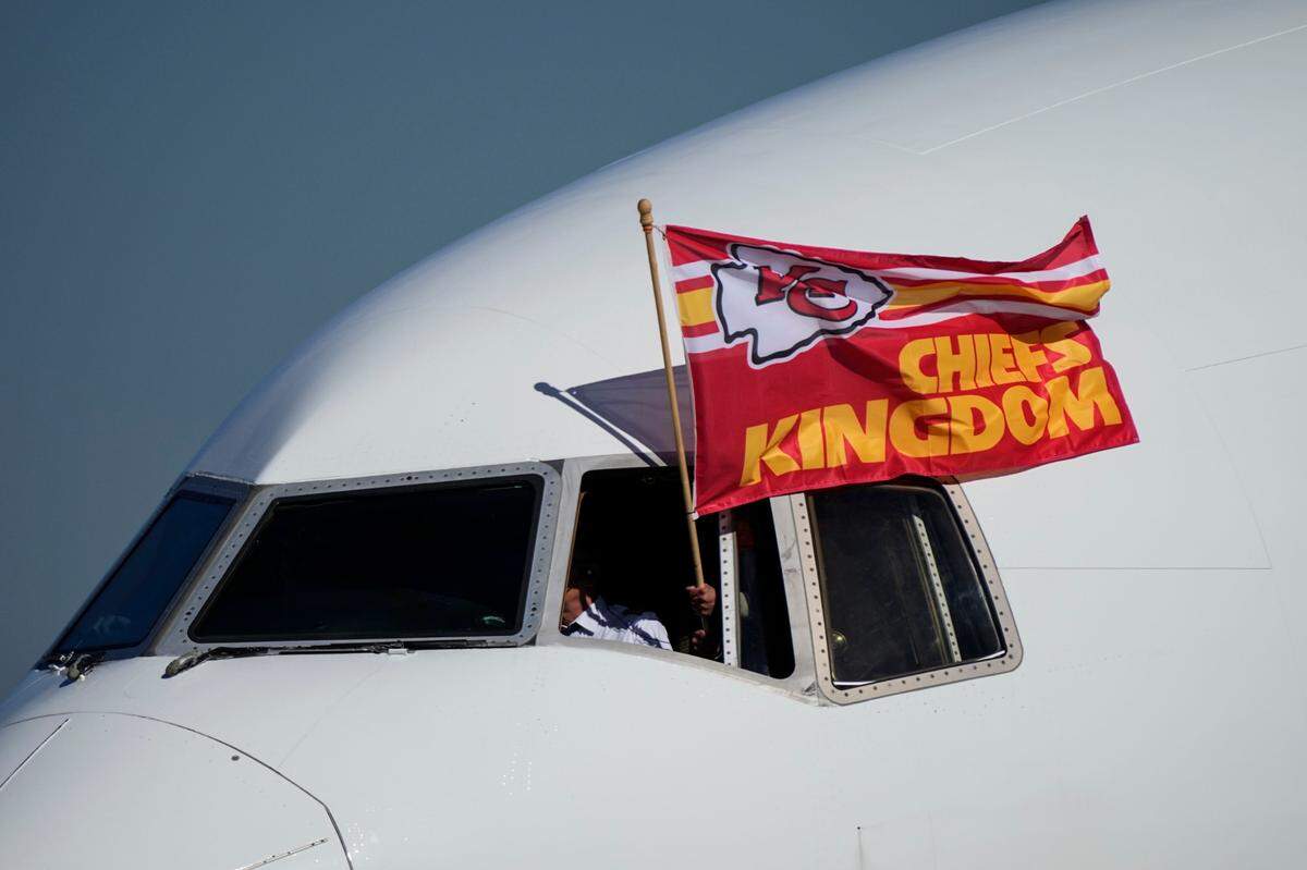A Kansas City Chiefs flag flies from the team plane as they arrive ahead of Super Bowl 57, Sunday, Feb. 5, 2023, in Phoenix. The Kansas City Chiefs will play the Philadelphia Eagles on Sunday.