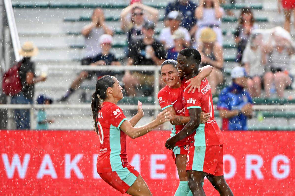 Kansas City Current forward Temwa Chawinga, right, celebrates with teammates Debinha and Lo’eau LaBonta after scoring against the North Carolina Courage on Sunday in Cary, N.C.