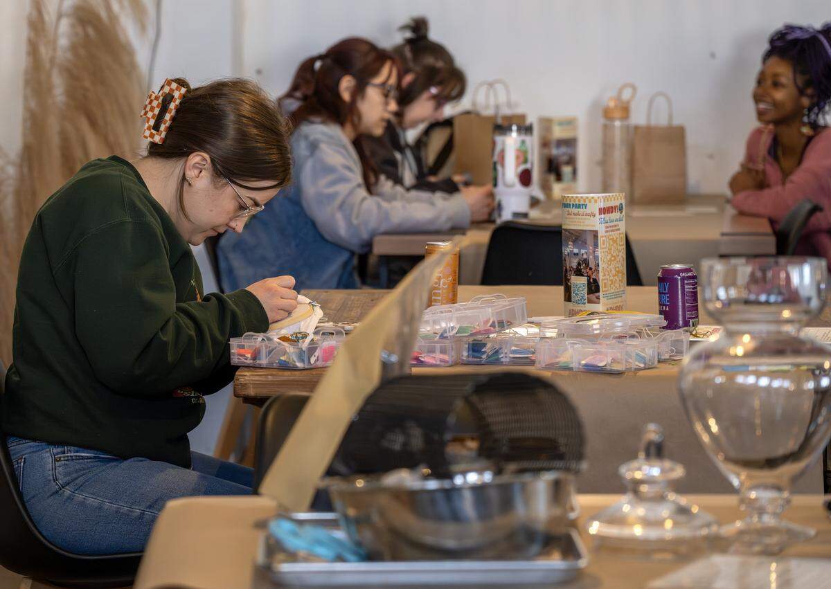 Guests sit at tables while making crafts at ADHDIY Craft Cafe on Saturday, Feb. 7, 2026, in Kansas City.