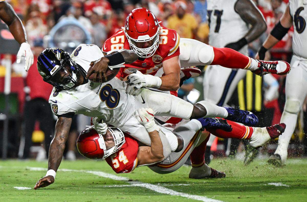 Kansas City Chiefs defensive end George Karlaftis (56) and linebacker Leo Chenal (54) stopped Baltimore Ravens quarterback Lamar Jackson (8) from running late in the fourth quarter Thursday, Sept. 5, 2024, at GEHA Field at Arrowhead Stadium.