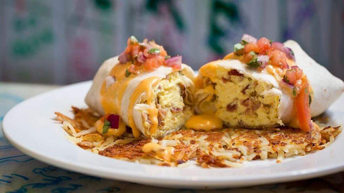 Tha Shack’s Make a Grown Man Cry breakfast burrito stuffed with bacon, sausage, scrambled eggs and onions and served on a bed of crispy hash browns and topped with house-made queso cheese and salsa fresca.