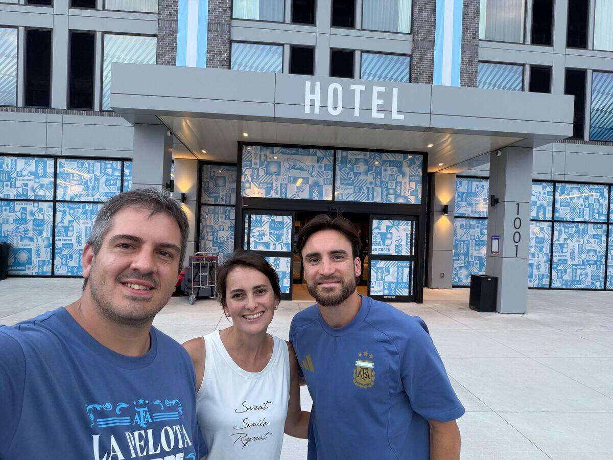 Dario Jerez Leavy and his wife, Isolina de la Vega, who own Los Hornos Argentinian Flavors, with Argentina player Nicolás Tagliafico outside the Origin Hotel, where Argentina’s national team is headquartered during the 2026 FIFA World Cup in Kansas City.