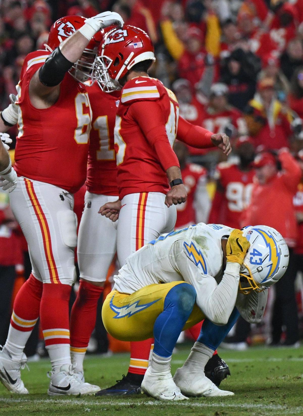 Los Angeles Chargers linebacker Troy Dye (43) held his helmet in disbelief while Kansas City Chiefs place kicker Matthew Wright (49) celebrated with guard Mike Caliendo (66) after kicking a last second field goal to give the Chiefs a 19-17 victory on Sunday, Dec. 8, 2024, at GEHA Field at Arrowhead Stadium.