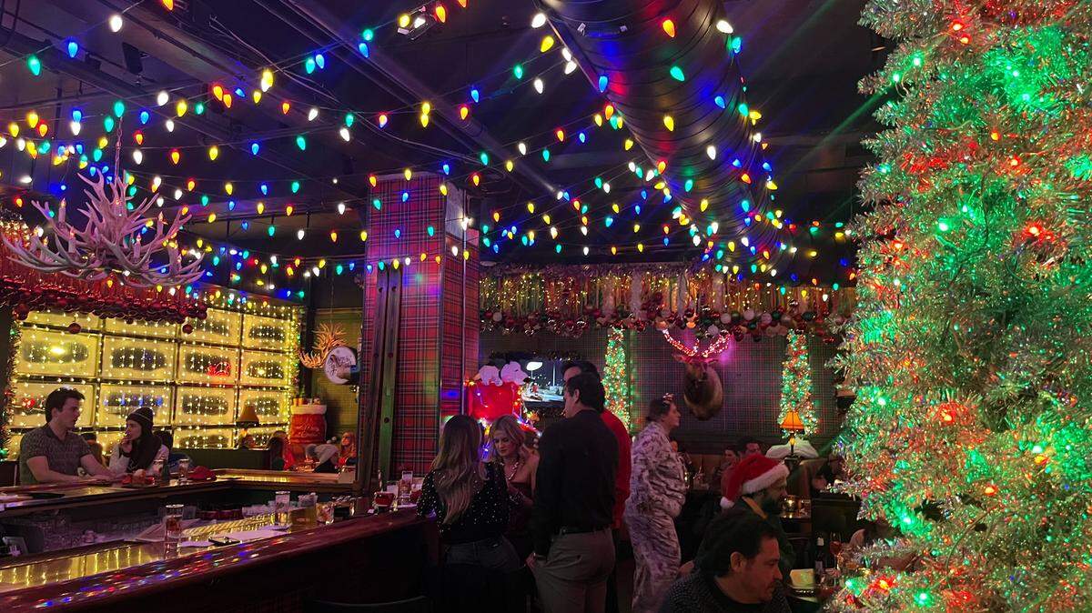 String lights, Christmas trees and other holiday decorations are on display inside The Rockhill Grille’s second floor lounge for Miracle, a Christmas-themed pop-up bar.