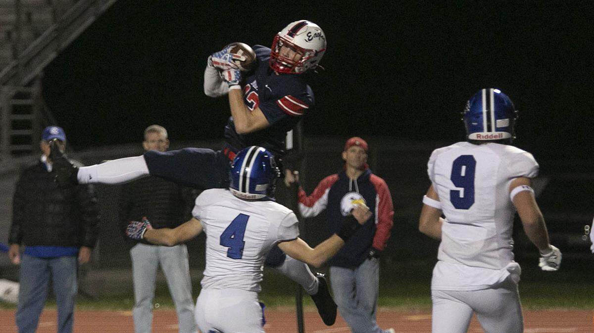 Olathe North’s Jason Scoma soars to haul in a pass against Olathe Northwest Friday night at the Olathe District Activities Center.