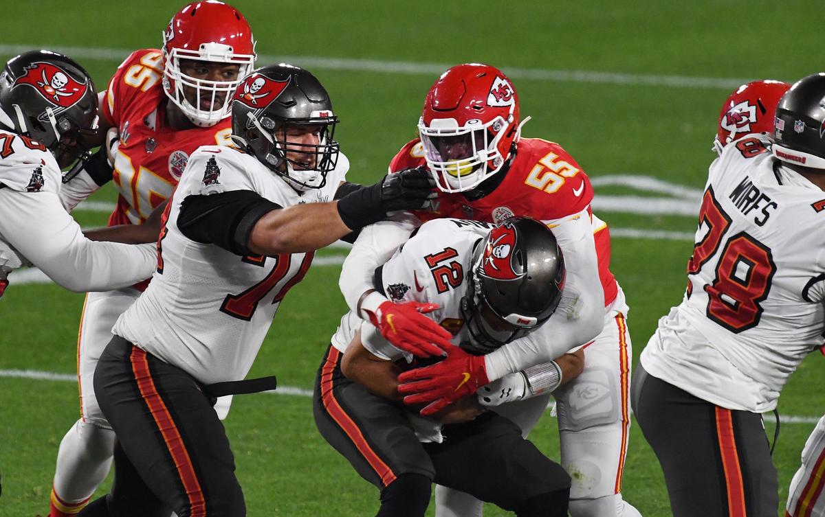 Tampa Bay Buccaneers quarterback Tom Brady is sacked by Kansas City Chiefs defensive end Frank Clark during the first quarter Sunday, February 7, 2021, at Super Bowl LV at Raymond James Stadium in Tampa, Florida.