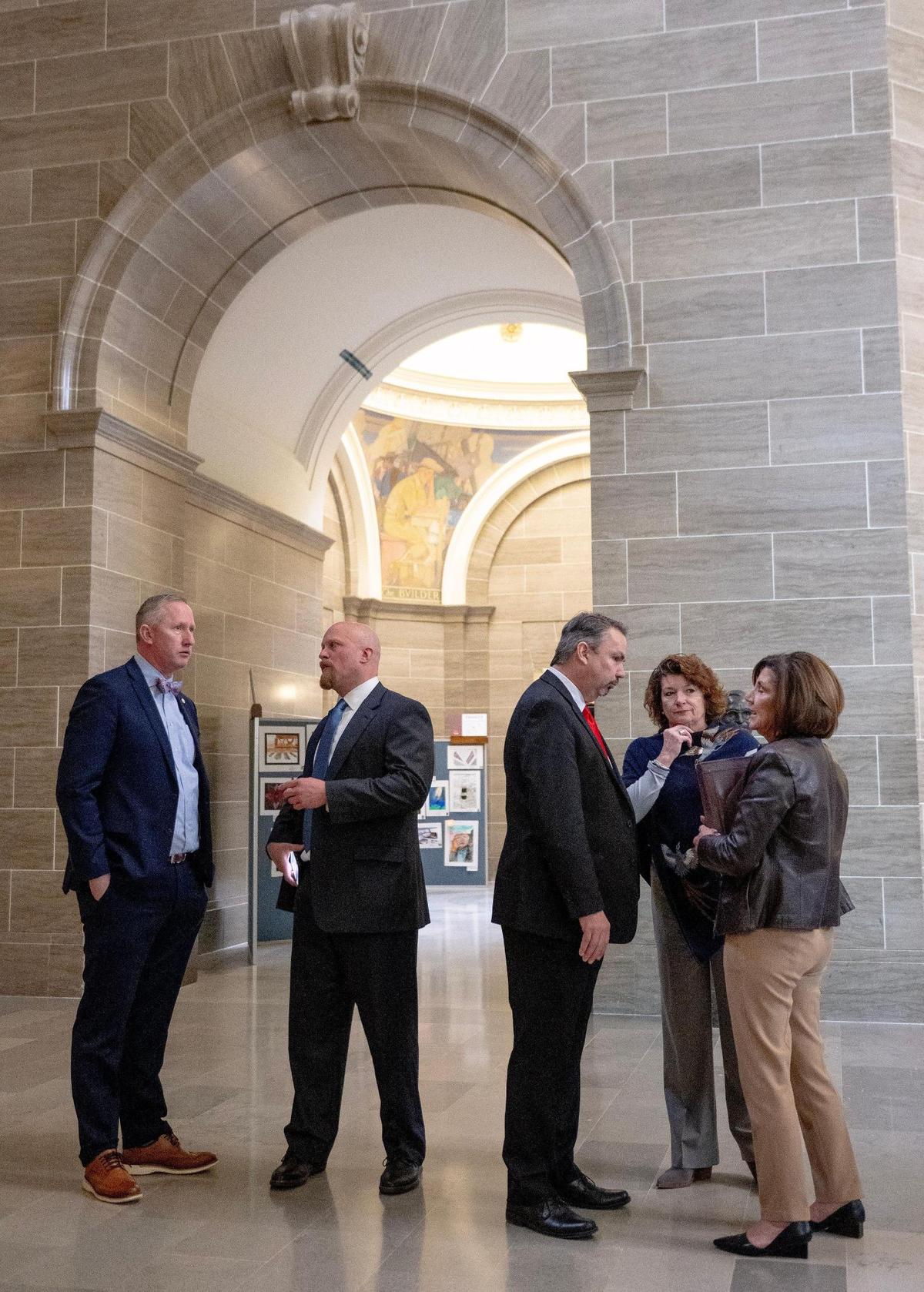 State Rep. Jamie Gragg, R-Ozark, speaks with Kyna Iman, center-right, and Kathi Harness, lobbyists representing the nursing industry on Tuesday, March 7, 2023, at the state Capitol in Jefferson City, Mo.