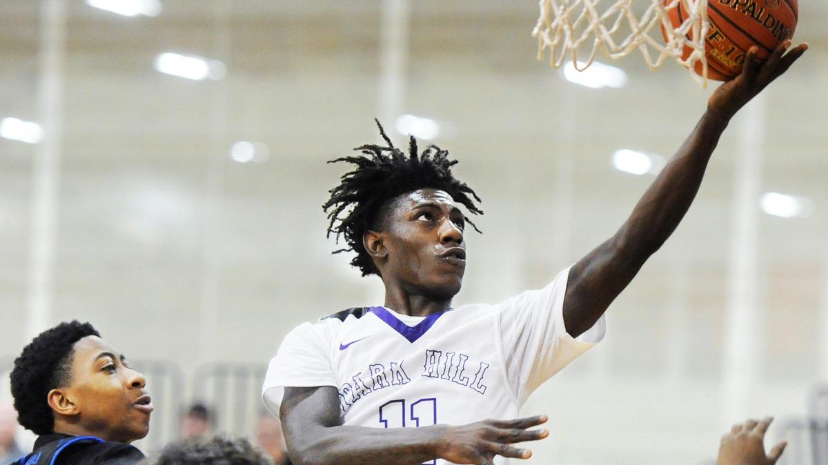 Park Hill South guard Lamel Robinson (11) moves in for a layup ahead of Raytown guard Karl Jackson during Friday afternoon’s game, Dec. 28, 2018, at William Jewell College in Liberty. Park Hill South won 69-53 in the Patterson Division semi-final game of the 39th Annual William Jewell High School Holiday Classic, which concludes Saturday, Dec. 29.