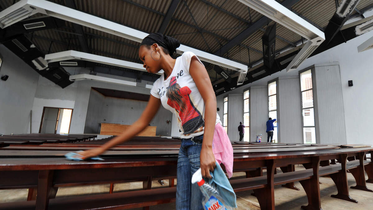 A woman cleans her table.