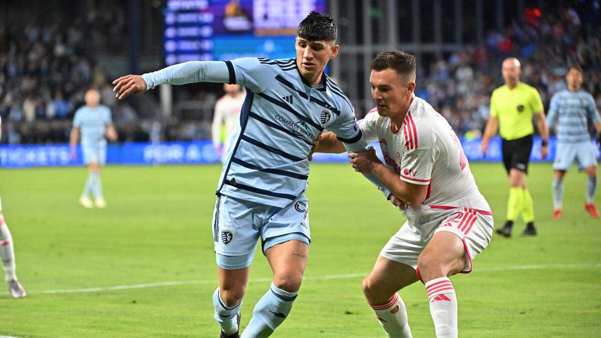 Sporting Kansas City forward Alan Pulido (9) controls the ball while defended by St. Louis City defender Kyle Hiebert (22) in the second half at Children’s Mercy Park on April 20, 2024.