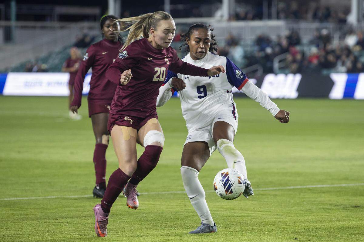 TCU defender Katana Norman (No. 9) kicks the ball away from Florida State defender Heather Gilchrist during a College Cup NCAA Division I women’s soccer semifinal match at CPKC Stadium in Kansas City, Missouri on Friday, Dec. 5, 2025. The Seminoles beat the Horned Frogs to advance.